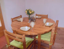 a dining room table in front of a wooden chair